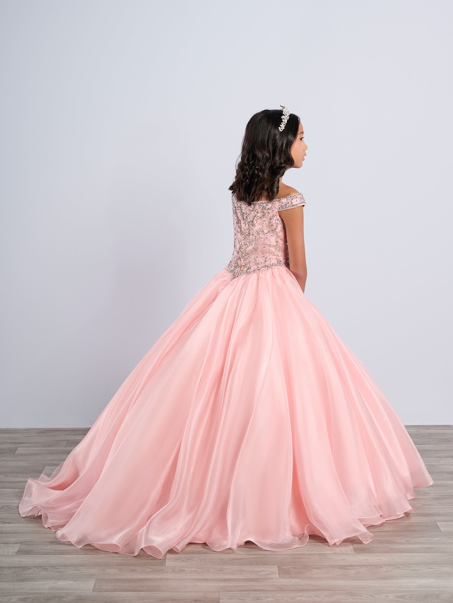 Elevate your little girl's pageant game with the Tiffany Princess 13788 dress. The stunning crystal bodice sparkles underneath the off-shoulder ballgown, making her stand out on stage. The A-line cut flatters any figure, creating a timeless and elegant look for any pageant.

Sizes: 2-16

Colors: Blush, Royal, White