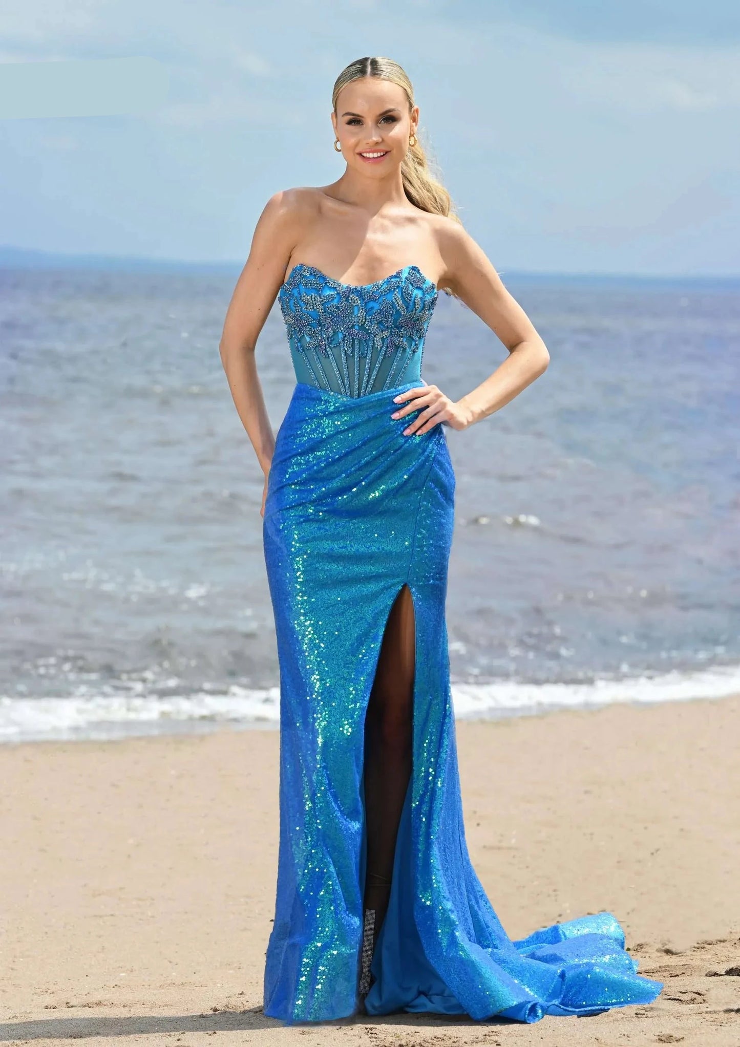 Expertly crafted by Colors Dress 3512, this long prom dress boasts a sequin and crystal corset, providing the perfect combination of sparkle and elegance. The sheer scoop neck adds a touch of allure, making this gown a stunning choice for pageants or any special occasion.