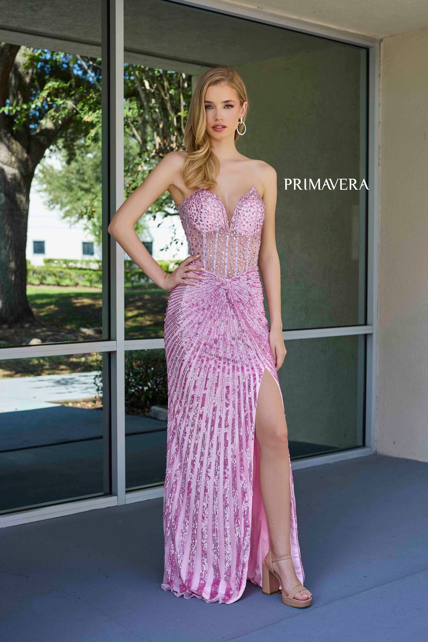 This elegant Primavera Couture 4304 Prom Dress features a sheer crystal corset, sequin detailing, and a dramatic slit in the skirt. The V-neckline adds a touch of sophistication, making it perfect for prom or pageants. Stand out from the crowd in this stunning gown.