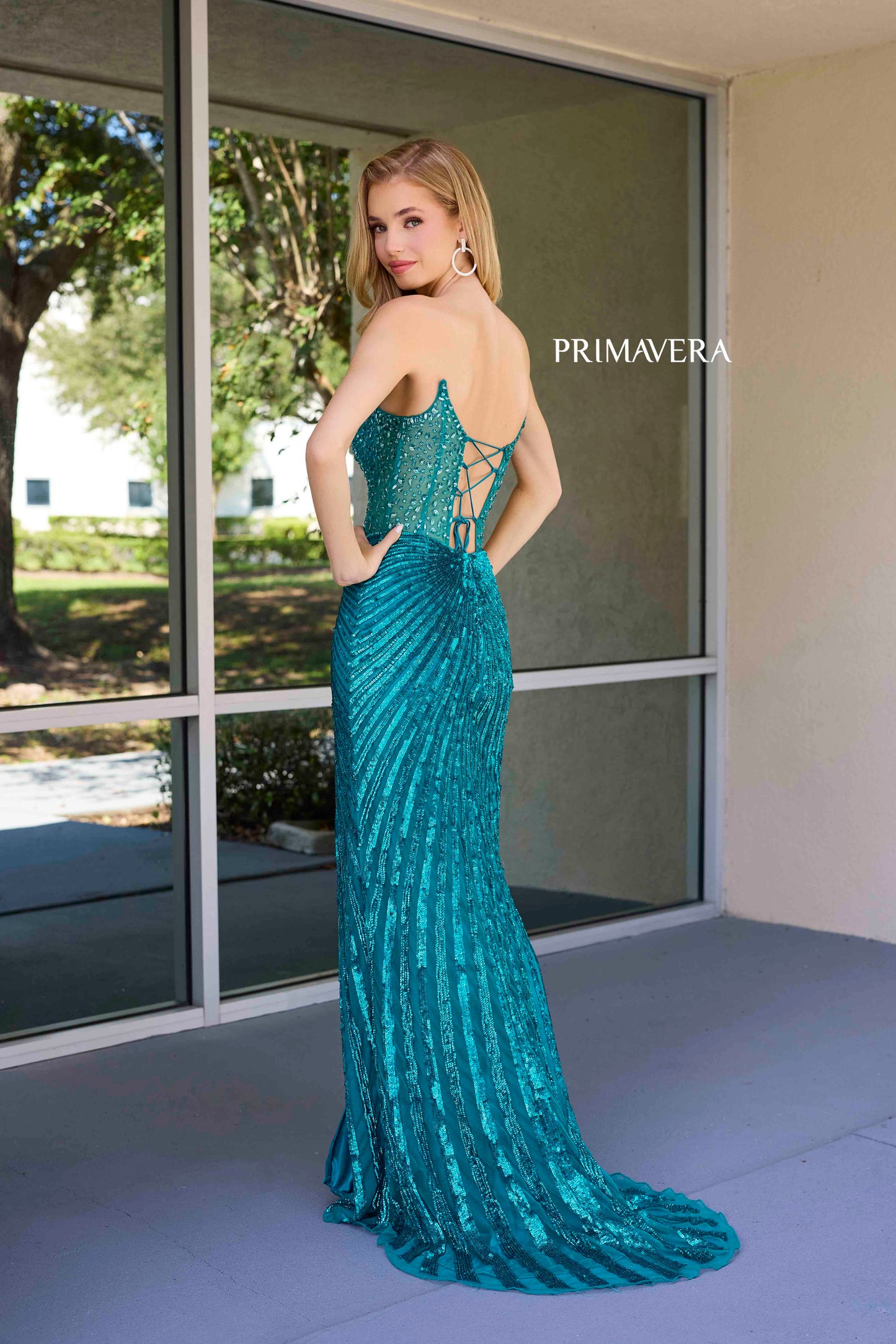 This elegant Primavera Couture 4304 Prom Dress features a sheer crystal corset, sequin detailing, and a dramatic slit in the skirt. The V-neckline adds a touch of sophistication, making it perfect for prom or pageants. Stand out from the crowd in this stunning gown.