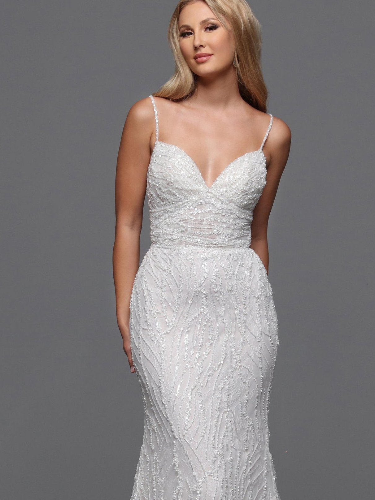 Shimmer and shine on your special day with the Davinci 50841 Sequin Beaded Lace Fitted Wedding Dress. Adorned with glittering sequins and delicate lace, this slip dress features beaded spaghetti straps and a flattering Empire-style waist. Walk down the aisle in style with this elegant and exclusive bridal gown.