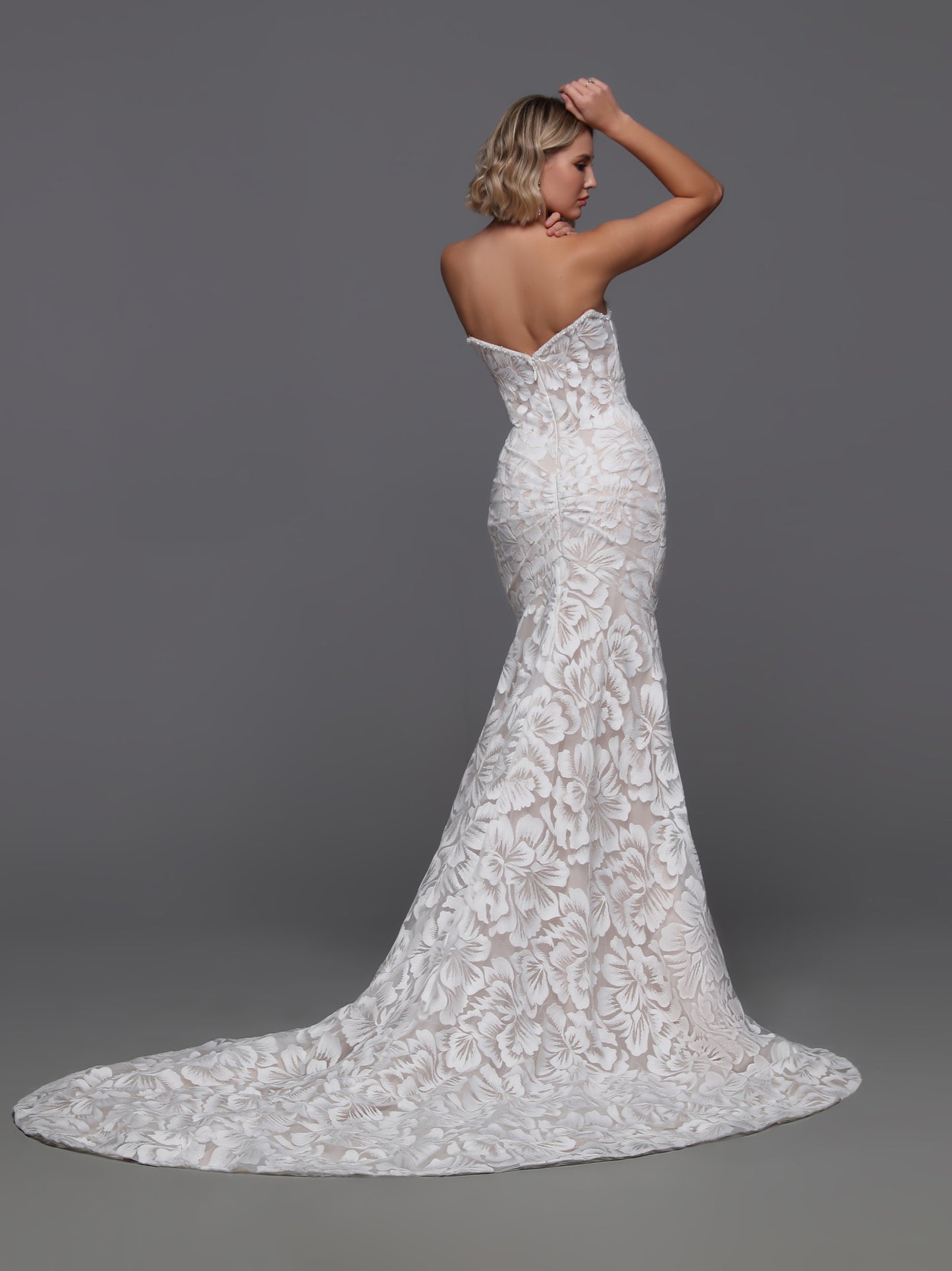 Indulge in elegance with the Davinci 50870 Embroidered Lace Wedding Dress. This strapless mermaid gown is adorned with delicate lace and shimmering beadwork along the bust and detachable spaghetti straps, exuding luxury and sophistication. The perfect choice for a glamorous and timeless bridal look. Experience true beauty on your special day.