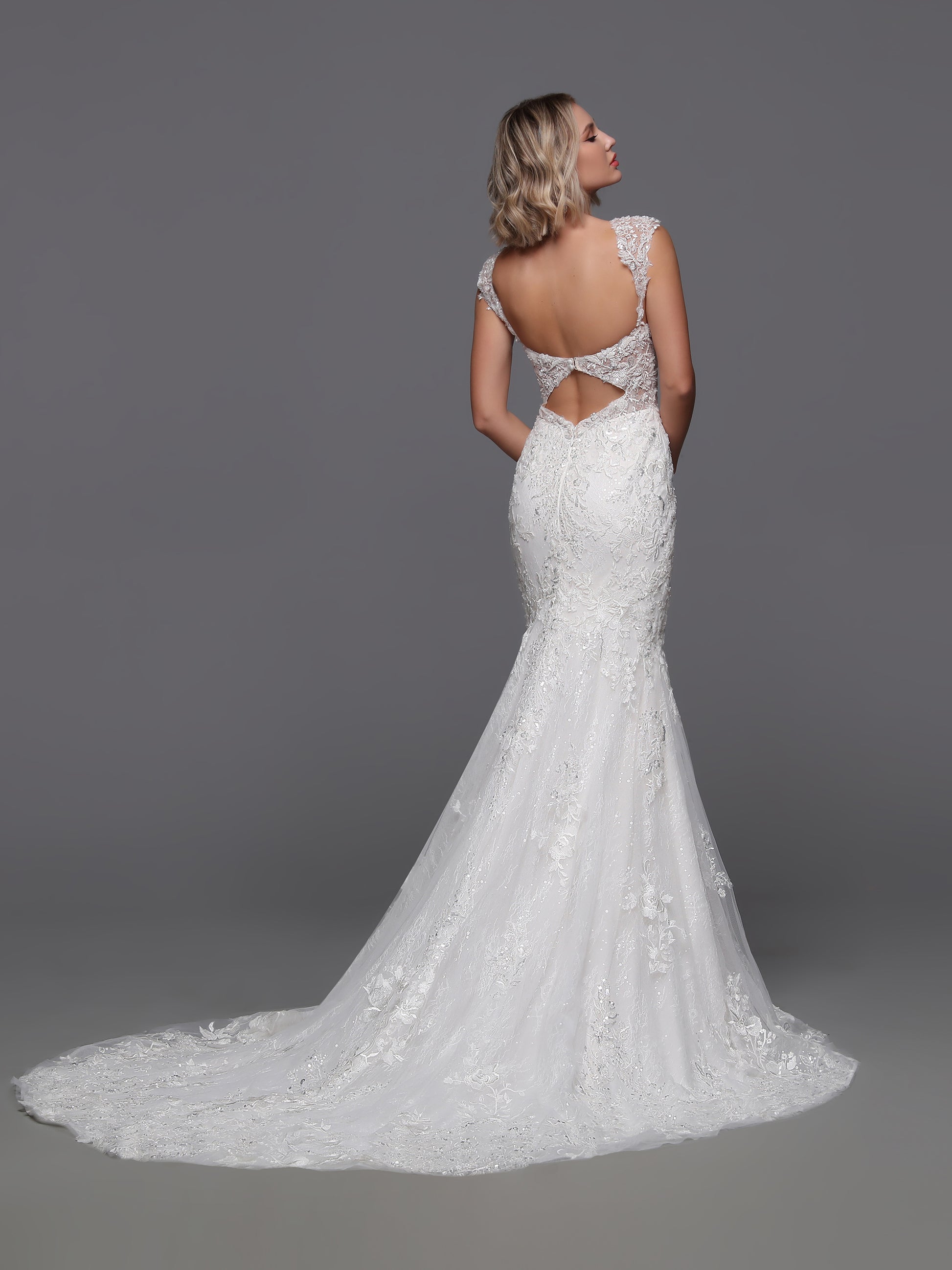 Experience the epitome of luxury with the Davinci Bridal 50875. This exquisite gown boasts a beaded sequin lace design, complemented by a detachable overskirt for added drama. The backless cut-out and beaded cap sleeves add a touch of sophistication to this elegant and exclusive wedding dress.