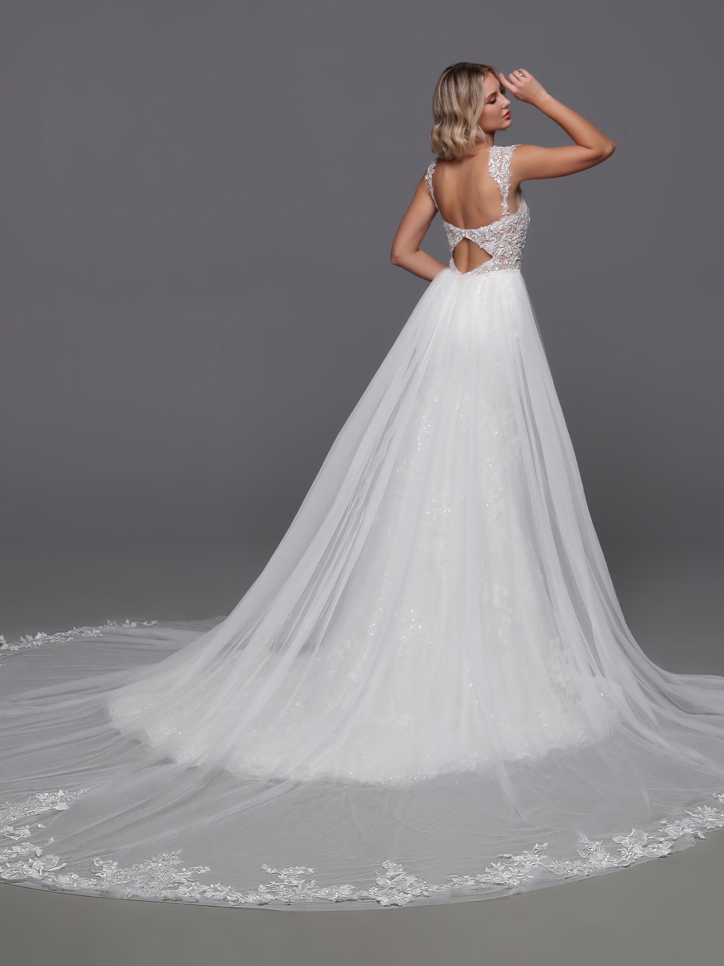 Experience the epitome of luxury with the Davinci Bridal 50875. This exquisite gown boasts a beaded sequin lace design, complemented by a detachable overskirt for added drama. The backless cut-out and beaded cap sleeves add a touch of sophistication to this elegant and exclusive wedding dress.