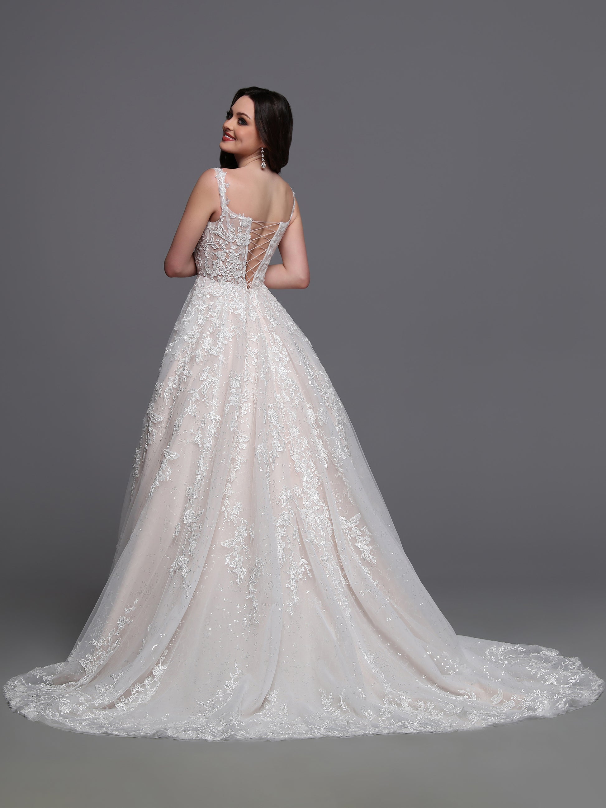 Step into a dreamy fairytale with our Davinci Bridal 50879 ball gown. The exquisite sequin lace and sheer cap sleeves add a touch of glamour to your special day. The corset and open back give a perfect fit and a captivating silhouette. Elegance meets sophistication, making it the perfect choice for your wedding.