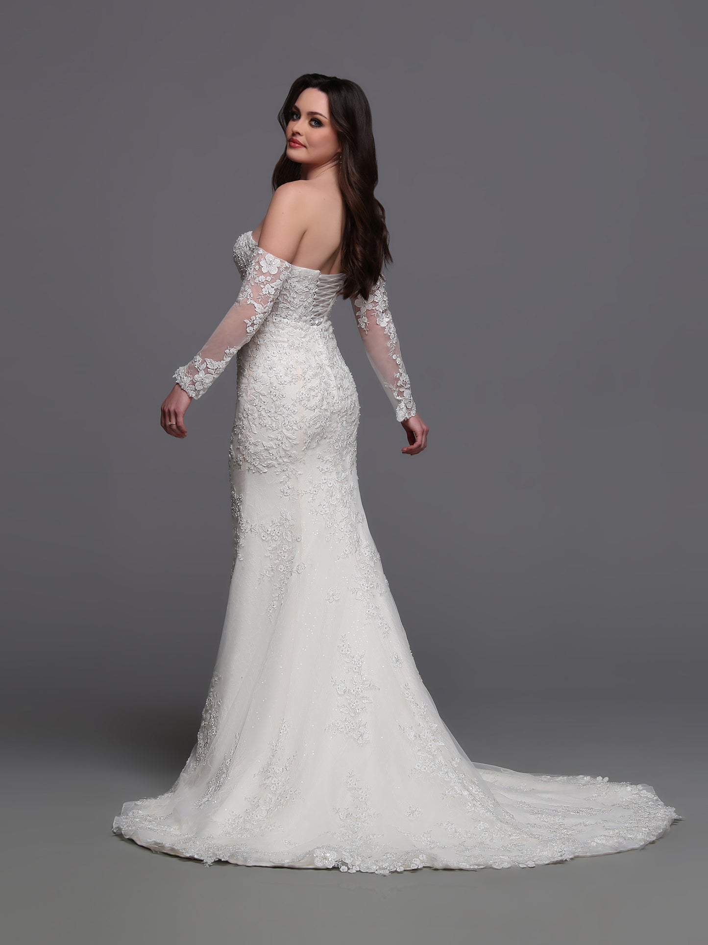 Indulge in elegance on your special day with the Davinci Bridal 50881 wedding dress. Flowing lace and intricate beading adorn the off the shoulder long-sleeves and corset back&nbsp; gown, leading into a stunning train. This mermaid-style dress is perfect for the modern bride who wants to make a statement. sequin shimmer