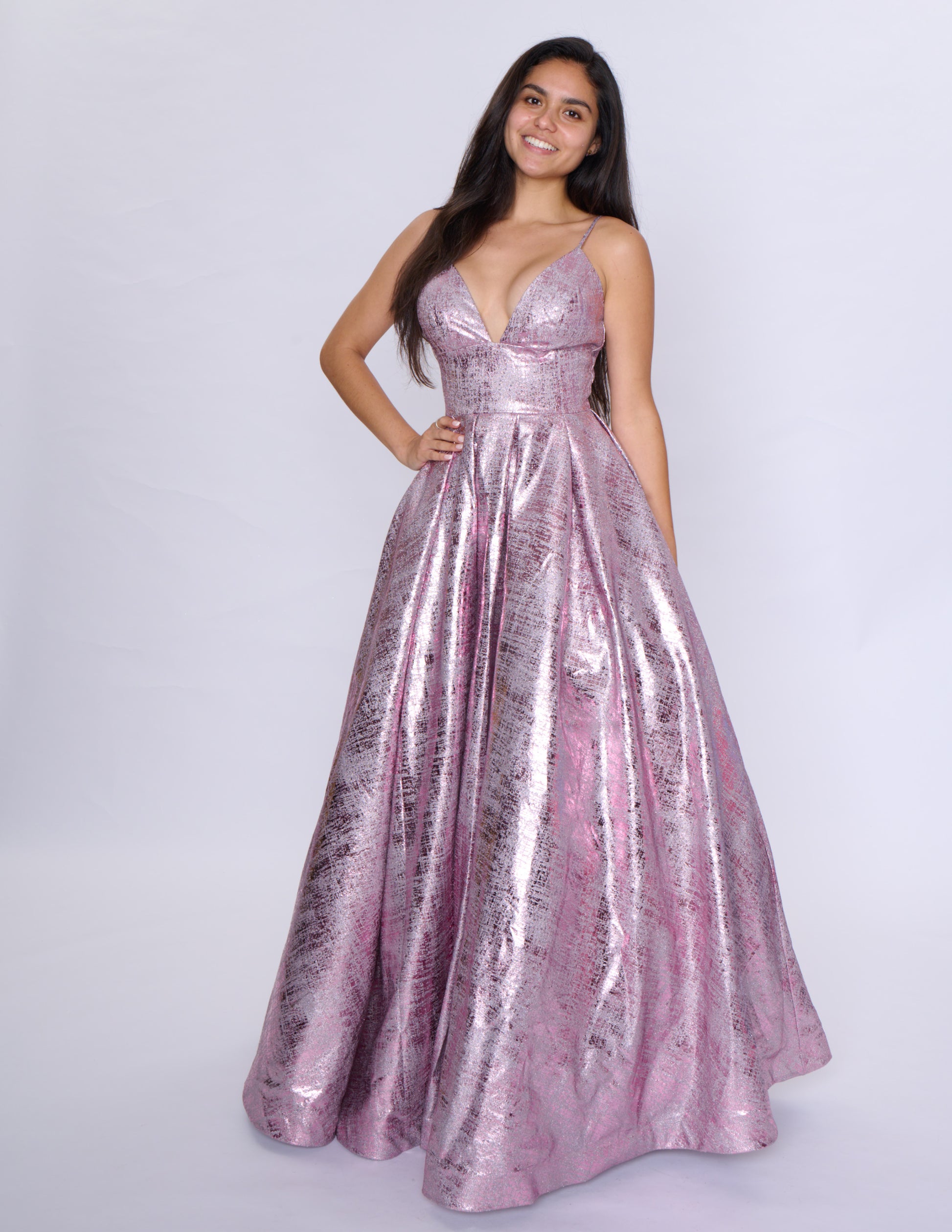 Elevate your formal attire with the Nina Canacci Metallic Ballgown. Stunningly designed with a corset-style bodice and V-neckline, this A-line gown exudes elegance and grace. Made with a metallic fabric, it adds a touch of shimmer to your look. Perfect for prom or any formal event, this dress will make you feel like royalty.

Sizes: 2-18

Colors: Black, Aqua, Rose