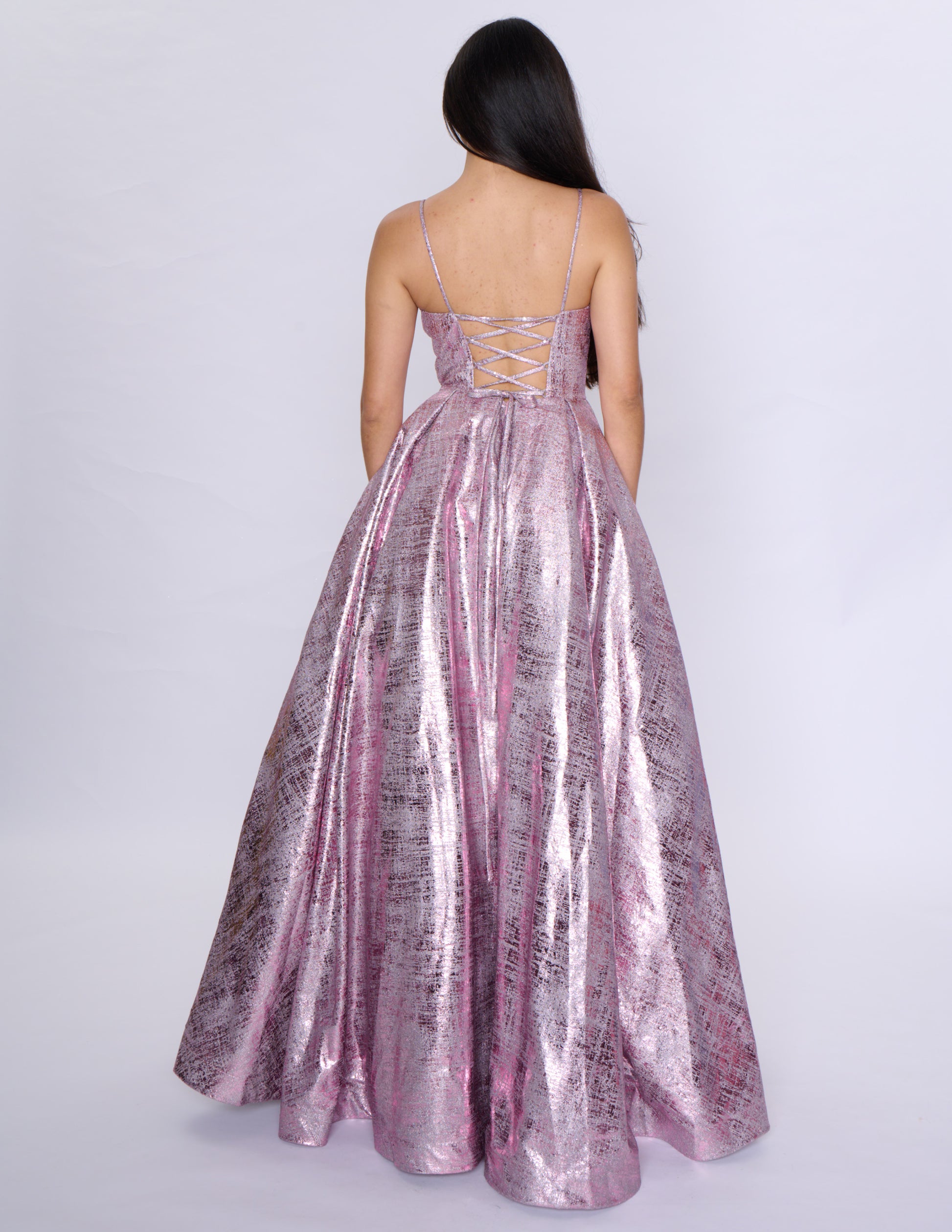 Elevate your formal attire with the Nina Canacci Metallic Ballgown. Stunningly designed with a corset-style bodice and V-neckline, this A-line gown exudes elegance and grace. Made with a metallic fabric, it adds a touch of shimmer to your look. Perfect for prom or any formal event, this dress will make you feel like royalty.

Sizes: 2-18

Colors: Black, Aqua, Rose