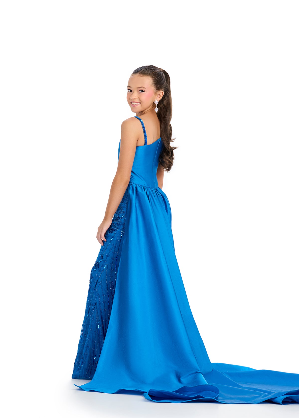 Elevate your little girl's style with the Ashley Lauren Kids 8287 Girls Pageant Jumpsuit. This fun and fashionable jumpsuit features intricate beading and a flowy overskirt for a glamorous look. Perfect for formal events, this jumpsuit will make your child feel confident and stylish. This taffeta jumpsuit is giving us all the glam! Featuring a one shoulder neckline and stunning beaded design, this look is complete with a sweeping train that takes our breath away!

One Shoulder
Fully Beaded Jumpsuit
Taffeta 