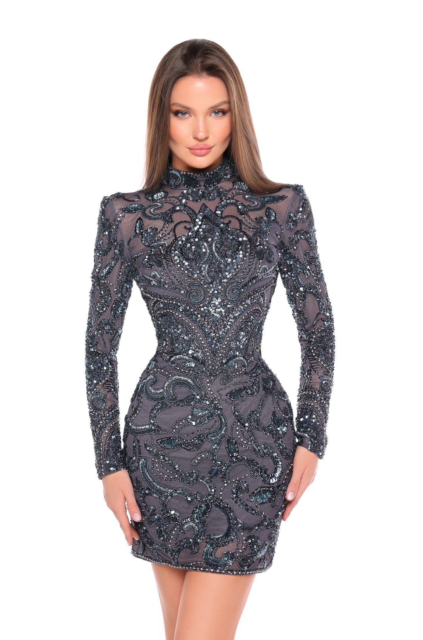 This elegant Amarra 88006 cocktail dress features a short, backless design and long sleeves adorned with intricate beading and sequins. Perfect for any homecoming or formal event, this dress exudes sophistication and style. The modern yet timeless design will make you stand out in any crowd. This dress features an intricate, ornate design adorned with swirling paisley patterns and sparkly beadwork throughout the garment. 