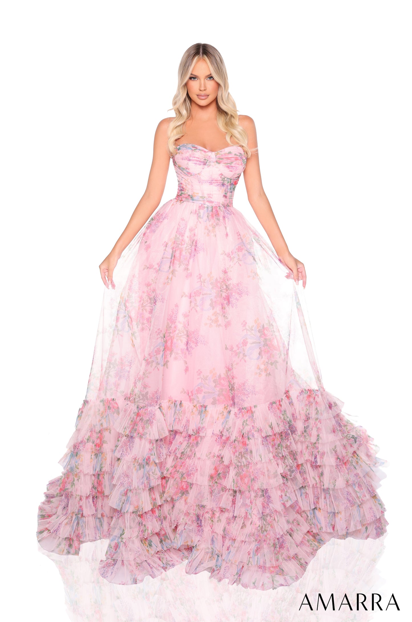 Experience the elegance and sophistication of the Amarra 88381 Ruffle Print Corset A Line Prom Dress. Perfect for formal events, this strapless ballgown features a stunning ruffle print corset and layered design. Make a statement with this one-of-a-kind dress that will surely turn heads. This enchanting floor-length ball gown is a vision of romantic whimsy in soft pink tulle adorned with a delicate floral print. The strapless bodice features a flattering semi-sweetheart neckline and is beautifully pleated, 