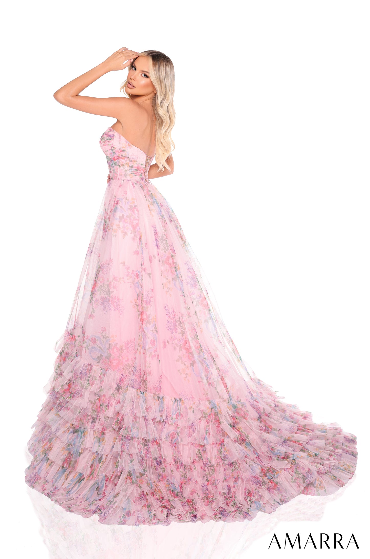 Experience the elegance and sophistication of the Amarra 88381 Ruffle Print Corset A Line Prom Dress. Perfect for formal events, this strapless ballgown features a stunning ruffle print corset and layered design. Make a statement with this one-of-a-kind dress that will surely turn heads. This enchanting floor-length ball gown is a vision of romantic whimsy in soft pink tulle adorned with a delicate floral print. The strapless bodice features a flattering semi-sweetheart neckline and is beautifully pleated, 