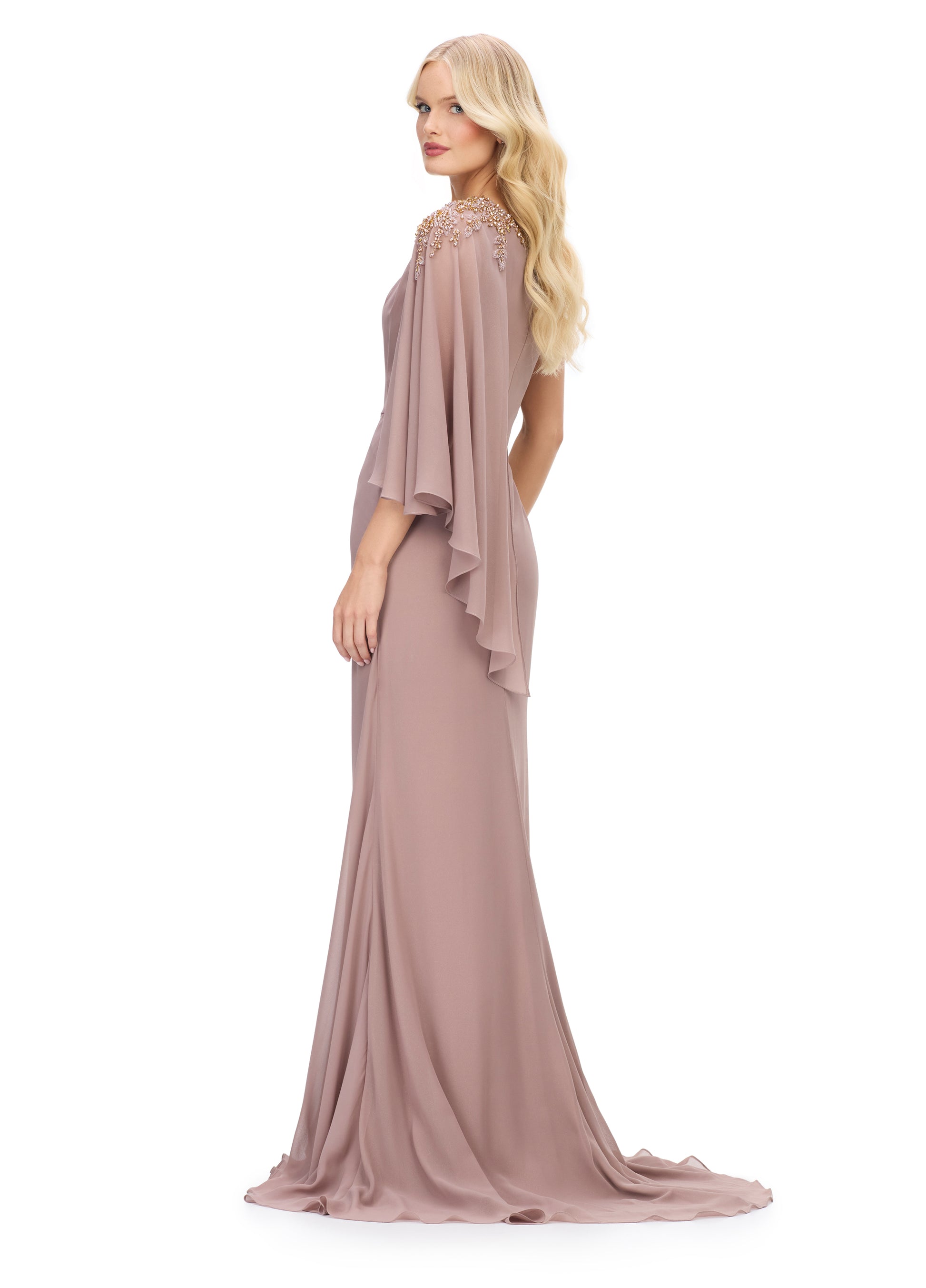 The Ashley Lauren 11701 evening gown boasts a one shoulder design with a single flowy chiffon sleeve, a ruched waist, and an embellished shoulder. This elegant and sophisticated dress is perfect for any special occasion, providing a flattering silhouette and eye-catching details. Elevate your evening look with this stunning piece.