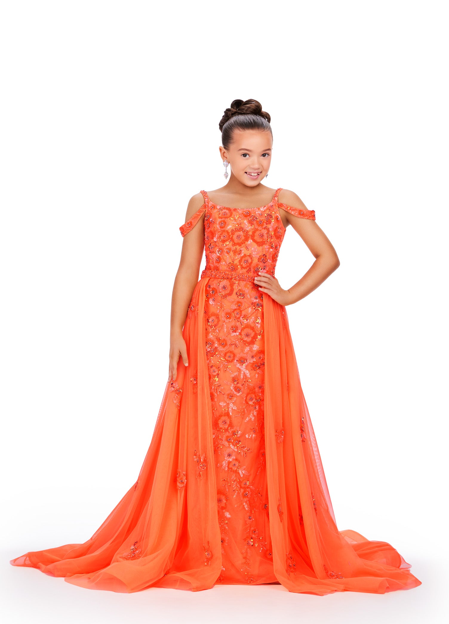 Expertly crafted for little girls who deserve to sparkle, the Ashley Lauren 8239 dress will make her shine on stage. The fitted silhouette flatters any figure while the beaded details and sequin overlay add a touch of glamour. Perfect for pageants and formal events. Bring the drama in this beaded column gown with shoulder draping straps. The removeable tulle overskirt is embellished with scattered beaded accents.