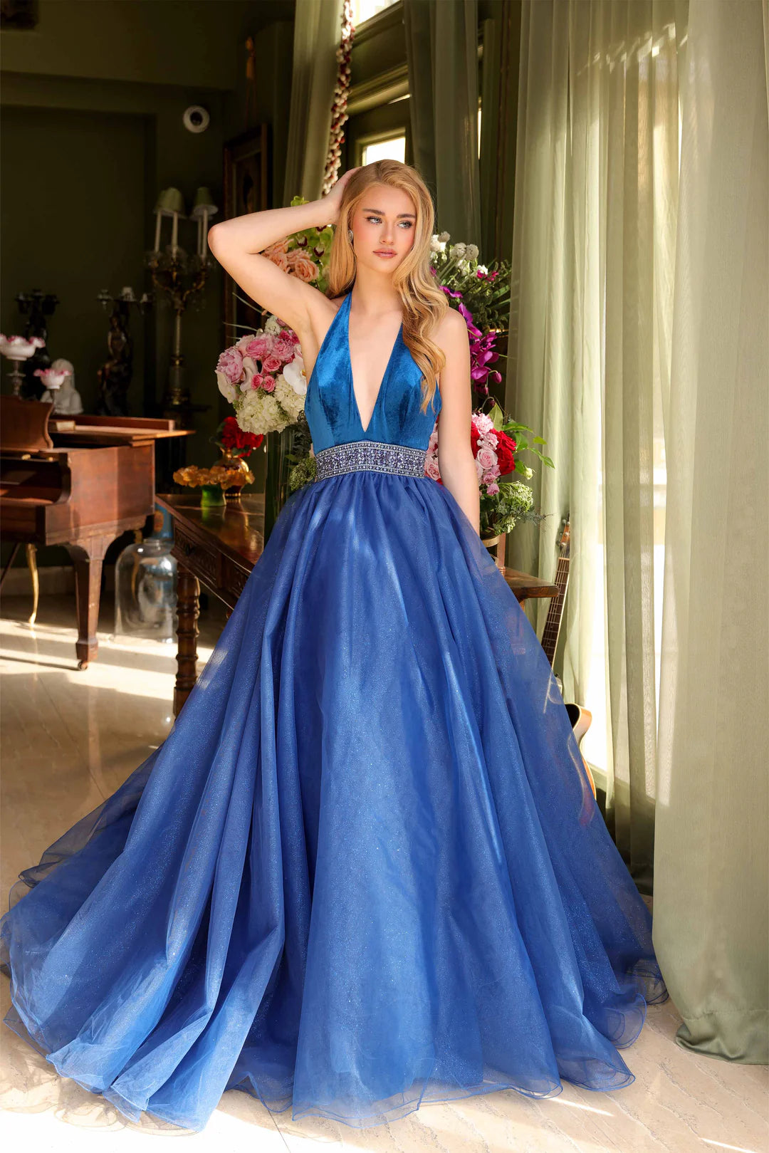 Be the center of attention in the stunning Ava Presley 39850 pageant dress. The velvet bodice with crystal belt adds a touch of elegance, while the glitter Lush A Line Tulle wire hem skirt makes a bold statement. Perfect for prom, homecoming, or any formal event.  Sizes: 00-14  Colors: Fuchsia, Peacock, Royal