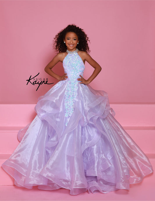 Dress to impress in the Sugar Kayne C371 Pageant Dress. This stunning A-line ballgown features sequin and ruffle details, a high neck, and layered skirt. Perfect for any pageant, this dress will make you stand out from the competition with its elegant and eye-catching design. Elevate your pageant game with Sugar Kayne. Embody elegance and glamour with this dazzling sequin mesh ballgown, designed to make you sparkle on stage. Featuring a halter neck with shimmering beading that highlights your neckline, and 