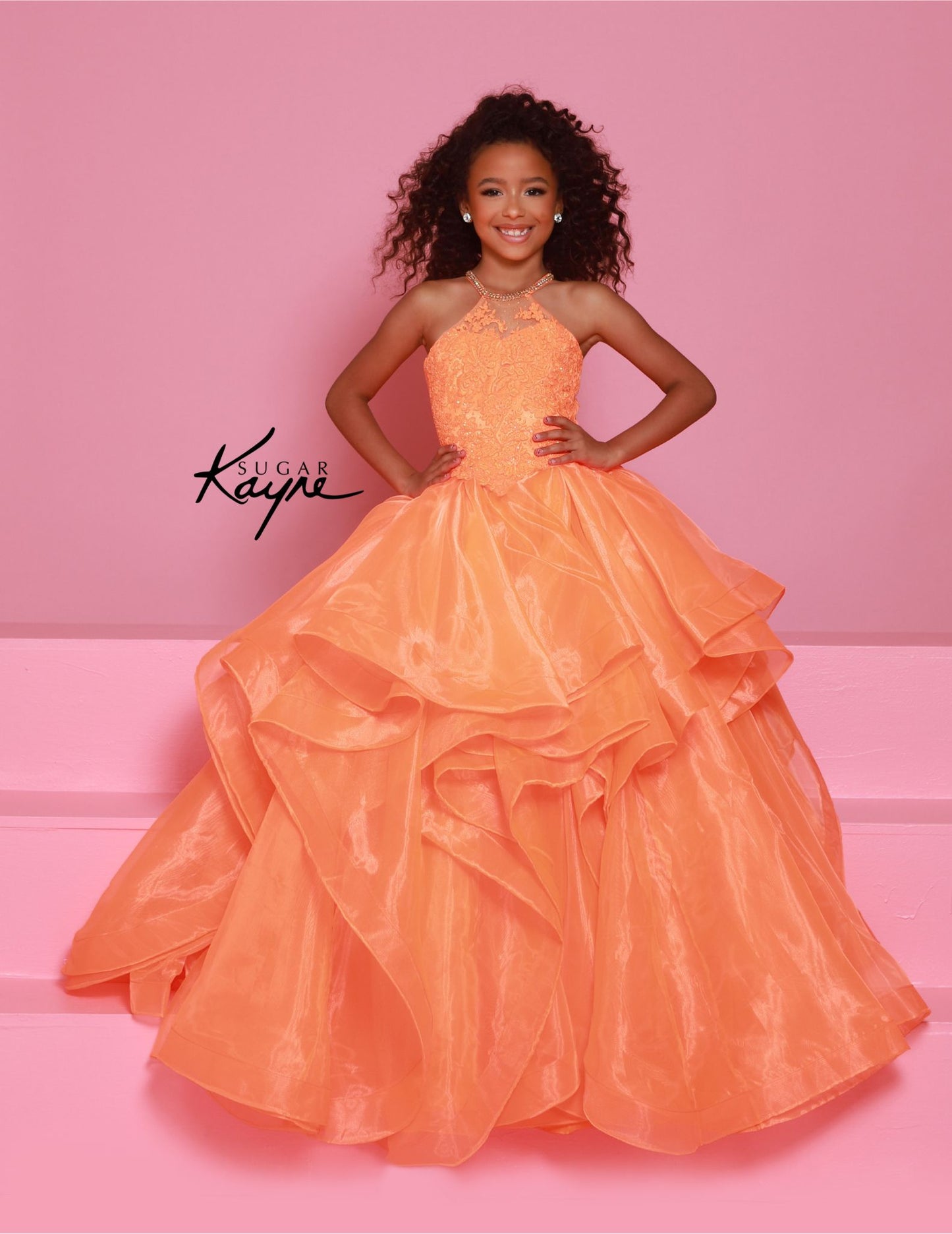 Introducing the elegant Sugar Kayne C375 Crystal Lace High Neck Girls Pageant Dress! With its intricate lace detailing and high neck design, this dress exudes sophistication and style. The ruffled A-line ballgown silhouette adds a touch of playfulness while maintaining a formal look. Perfect for any special occasion. Make a stunning impression at your next pageant with this exquisite halter-neck gown. Featuring a beaded bodice that adds a dazzling touch of sparkle, this gown offers both elegance and comfort