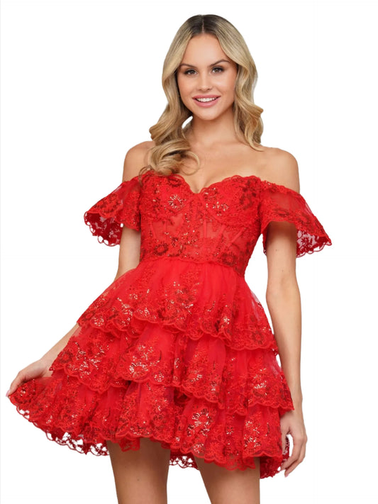 This homecoming dress Colors 3347 features a beautiful 17-inch lace ruffle skirt and a sheer corset bodice, along with intricate lace ruffle sleeves. Combining elegance and playfulness, this dress is perfect for standing out at any formal event. Ruffle layered tulle and lace hem skirt adorned with sequins. Corset style bodice!