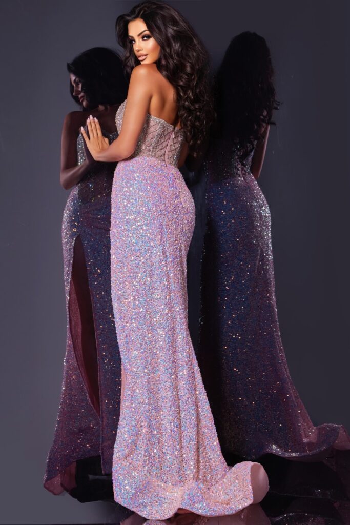 Be the star of any formal event with the Jovani D5742 dress. Featuring a sheer crystal corset, sequin detailing, and a high slit, this strapless prom gown exudes elegance and glamour. Showcase your figure and dazzle the crowd with this stunning pageant dress. Turn heads with this stunning full-length gown, featuring a sweetheart neckline that elegantly complements a fitted corset bodice adorned with intricate sequin embellishments. The dress flows seamlessly into a silhouette with a high slit, offering a bl