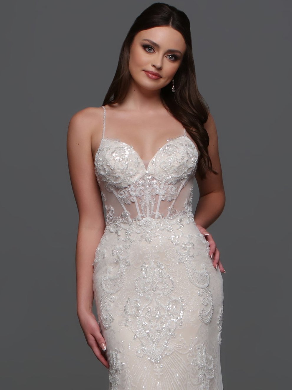 Elevate your wedding day look with the F123 Long Beaded Sheer Wedding Dress by Davinci Bridal. Featuring a mermaid silhouette and shimmering beadwork, this gown exudes luxury and sophistication. The sheer detailing and V-neckline add an elegant touch, making you the center of attention on your special day. A lovely blend of visual textures, this wedding dress features a sheer beaded lace applique bodice and a linear-pattern tulle skirt with a sheer overskirt with lace that matches the bodice.