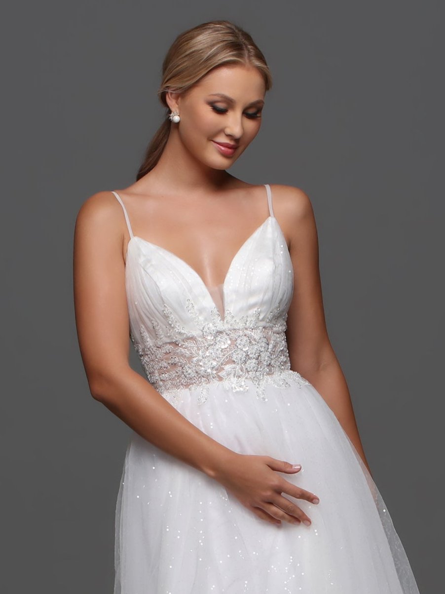 Elevate your bridal look with our Davinci Bridal F130 wedding dress. This exquisite A-line gown features intricate beading and shimmering sequins, adding a touch of glamour to your special day. The sheer bodice and V-neckline enhance your figure, while the flowing skirt creates a romantic silhouette. Be a vision of luxury and sophistication on your wedding day. Softly elegant, this A-line wedding gown has a ruched bustline and a wide sheer waistband with beaded applique. The full tulle skirt gives the dress