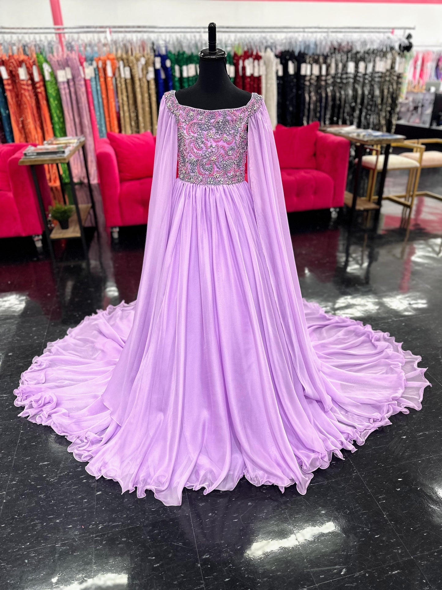 The Samantha Blade 1022 Girls Pageant Dress is the perfect choice for your little one's big day. With a stunning beaded crystal bodice and off-the-shoulder cape sleeves, she'll shine like a star. The chiffon ballgown train adds a touch of elegance and ensures she'll make a grand entrance.