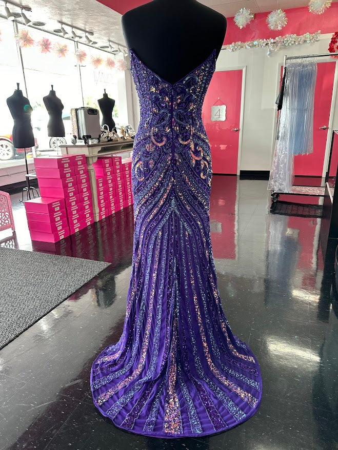 The Jovani 38707 prom dress is a stunning and sophisticated gown designed for formal occasions, making it a perfect choice for prom. This floor-length dress is made from delicate mesh fabric, which gives it a lightweight and semi-transparent quality, adding a touch of elegance to the overall look.