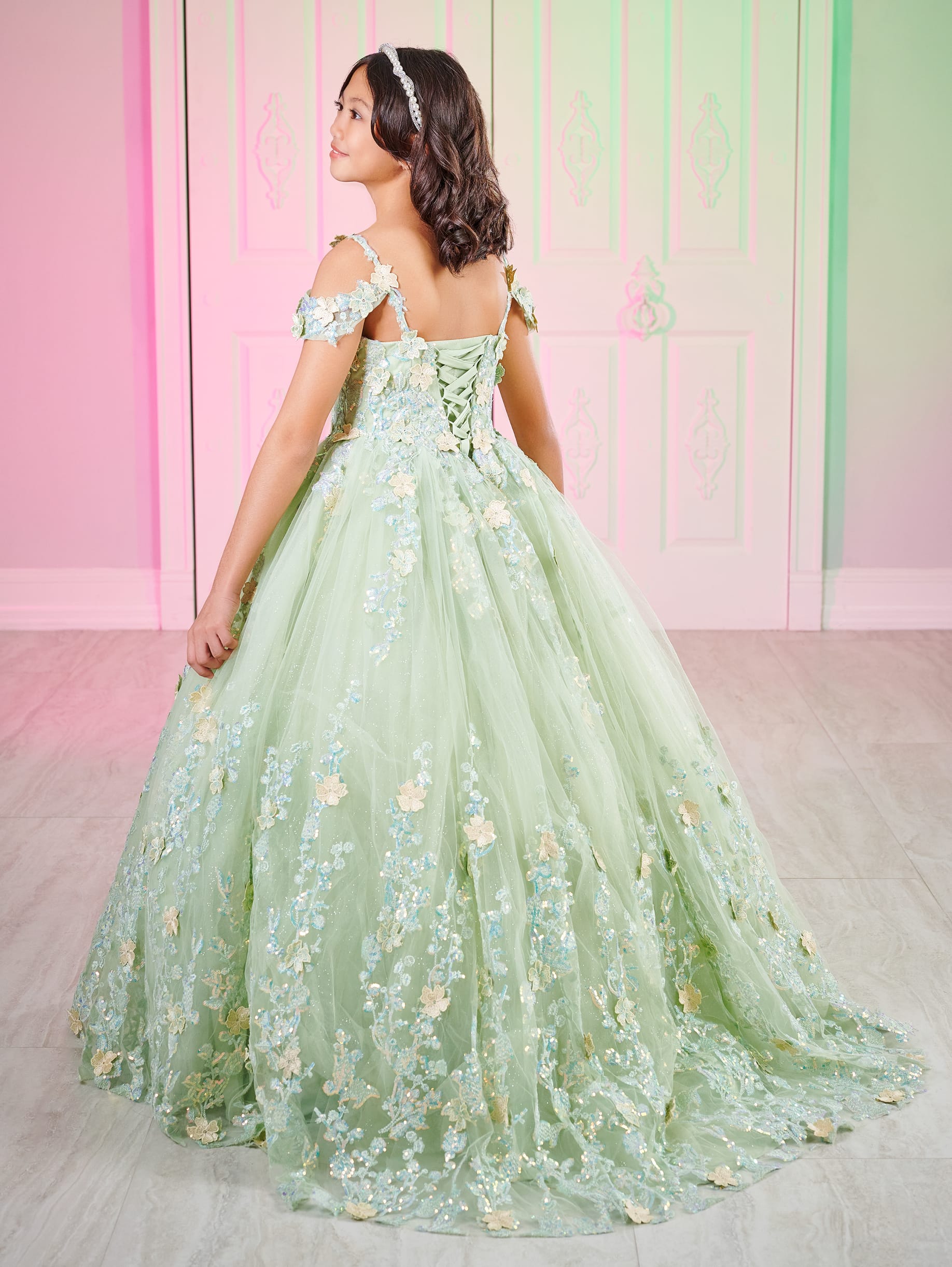 This Tiffany 80002MQ Girls Pageant Dress is made with 3D lace and shimmer fabric, featuring an elegant off-the-shoulder design and a mini quince gown style. Perfect for pageants, this dress will make your little girl feel like a princess.