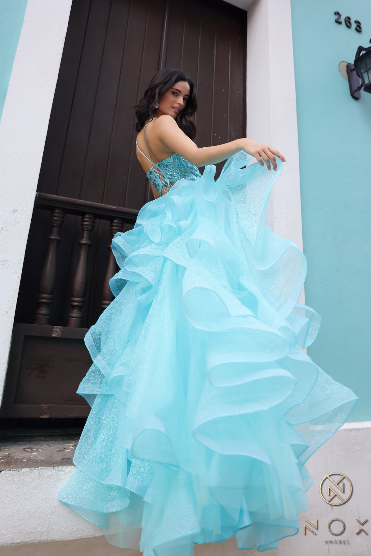 Elevate your formal look with the Nox Anabel R1433 Sheer Sequin Corset Ruffle Prom Dress. The sheer sequin corset adds a touch of shimmer, while the ruffled detail and V-neckline create a stunning silhouette. Perfect for prom or any formal event, this dress is sure to impress.

Size: 2

&nbsp;Color: Aqua