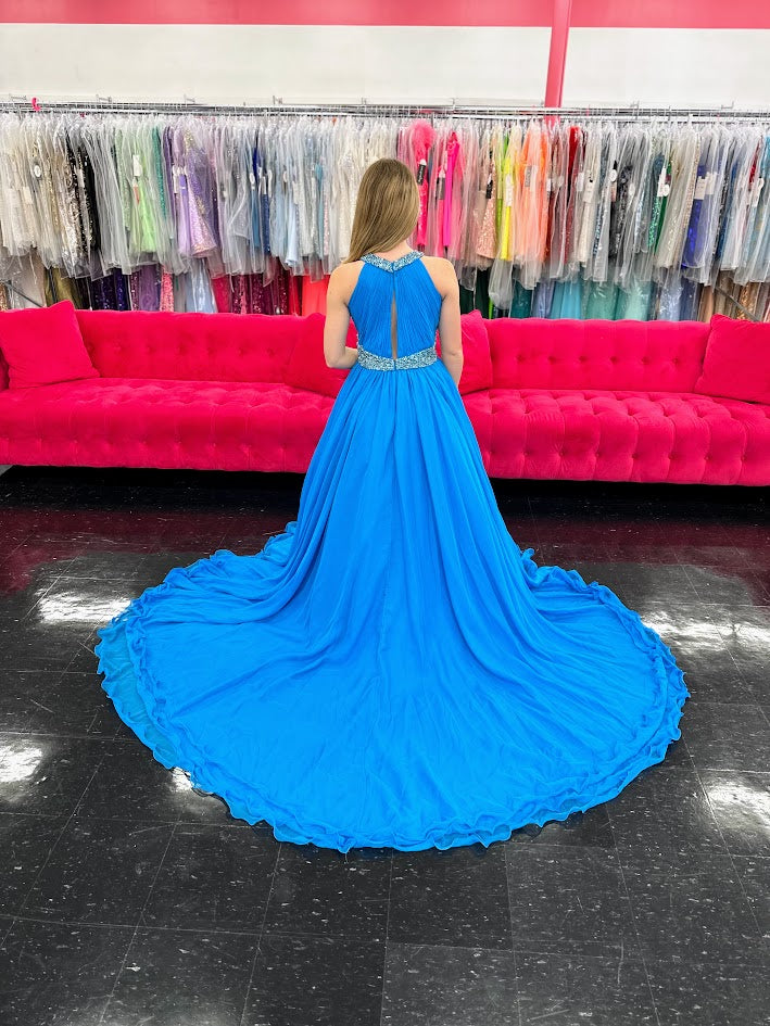 Samantha Blake 1102 Girls Pageant Dress. This stunning A Line Chiffon gown, complete with a detachable crystal Embellished cape and chiffon material, will make any young girl feel like a princess. With its train design, it offers elegance and grace for any special occasion. Get yours today and make a statement at your next Pageant.