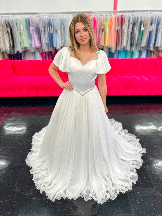 Make your little girl feel like a princess in the Samantha Blake 1126 Girls Pageant Dress. Featuring Chiffon ruffle cap sleeves and a satin bodice, this formal gown exudes elegance and charm. With an A-line silhouette, it flatters any figure and is perfect for pageants or special occasions.