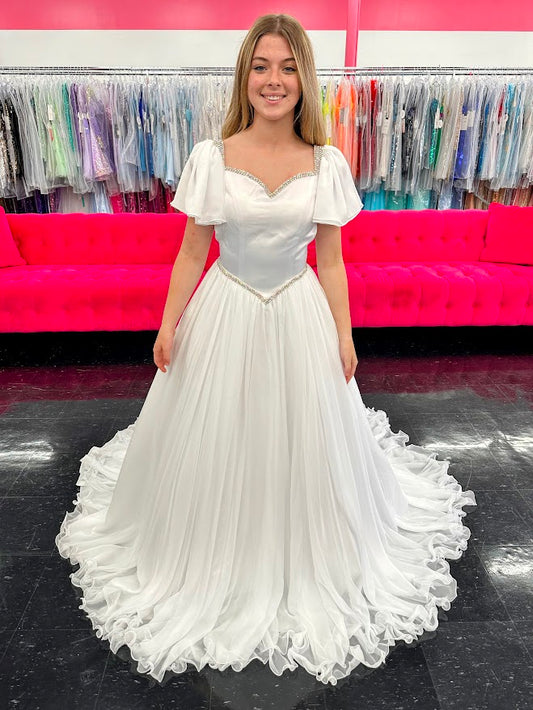 Make your little girl feel like a princess in the Samantha Blake 1126 Girls Pageant Dress. Featuring Chiffon ruffle cap sleeves and a satin bodice, this formal gown exudes elegance and charm. With an A-line silhouette, it flatters any figure and is perfect for pageants or special occasions.