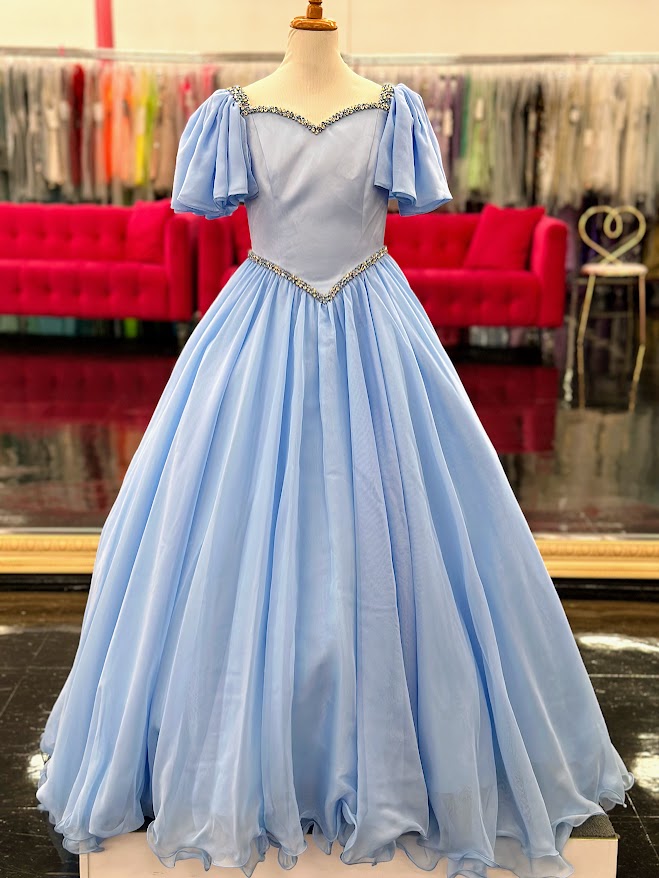 Make your little girl feel like a princess in the Samantha Blake 1126 Girls Pageant Dress. Featuring Chiffon ruffle cap sleeves and a satin bodice, this formal gown exudes elegance and charm. With an A-line silhouette, it flatters any figure and is perfect for pageants or special occasions.