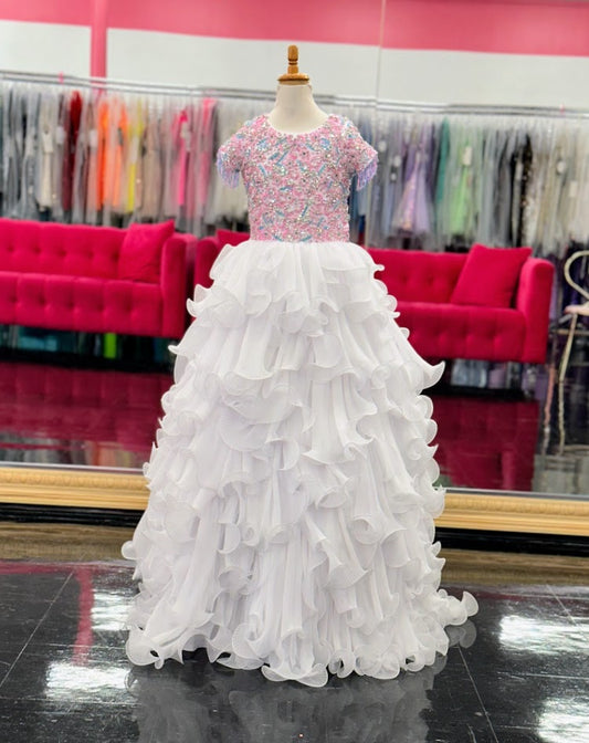 The Samantha Blake 1138 Long Pleated Girls Pageant Dress is a stunning showcase of beaded fringe and crystal embellishments. The Layered pleated Skirt design adds texture and dimension to the gown, making it a standout choice for any pageant. 