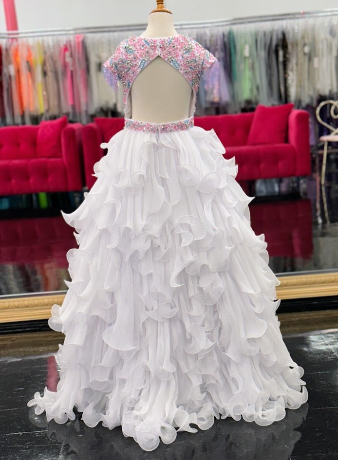 The Samantha Blake 1138 Long Pleated Girls Pageant Dress is a stunning showcase of beaded fringe and crystal embellishments. The Layered pleated Skirt design adds texture and dimension to the gown, making it a standout choice for any pageant. 