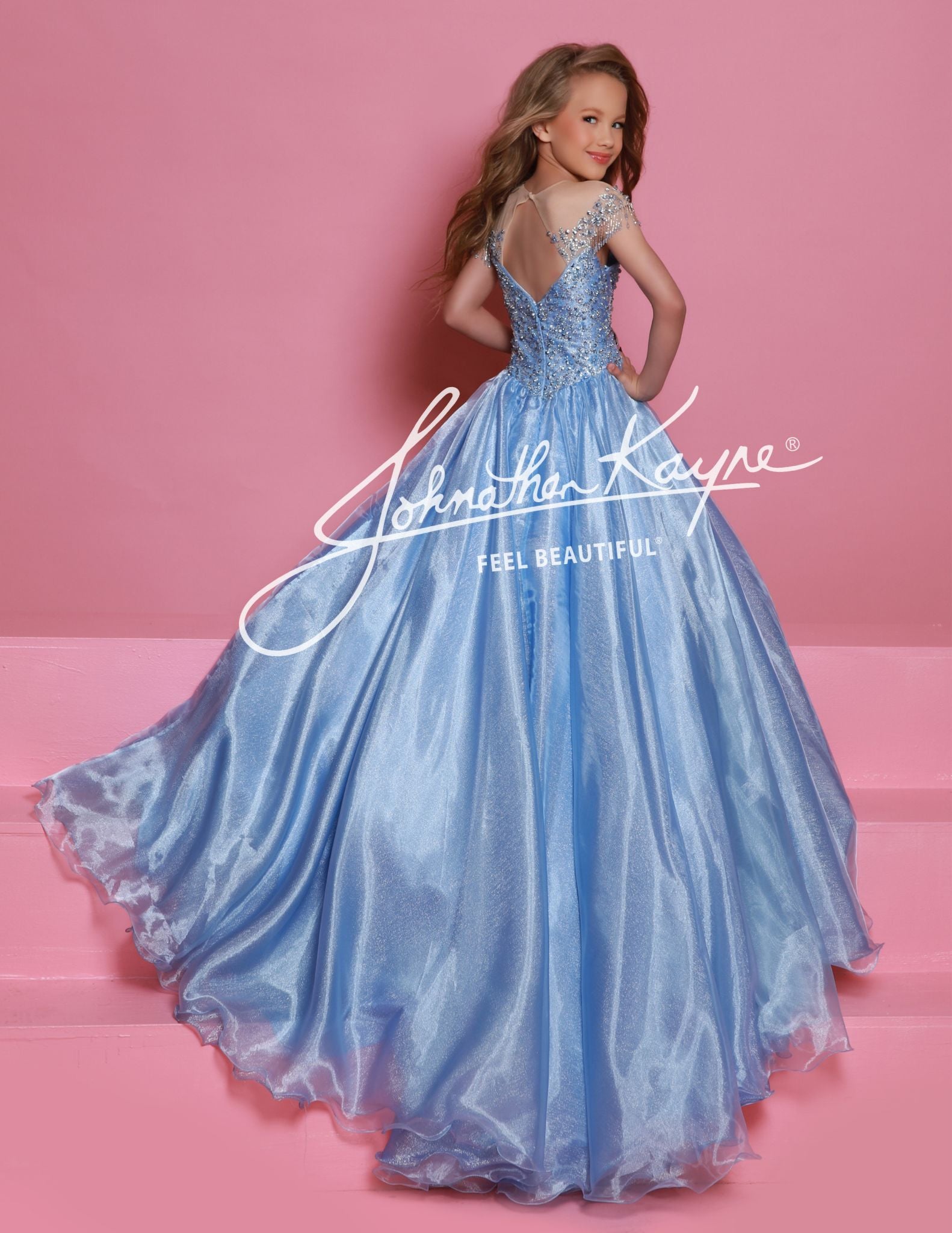  This Sugar Kayne C357 Girls Pageant Dress is a stunning ballgown that will make your little girl stand out on stage. The off the shoulder design and fringe detailing add a touch of glamour, while the shimmer fabric gives the dress a beautiful shine. Perfect for formal events and pageants.