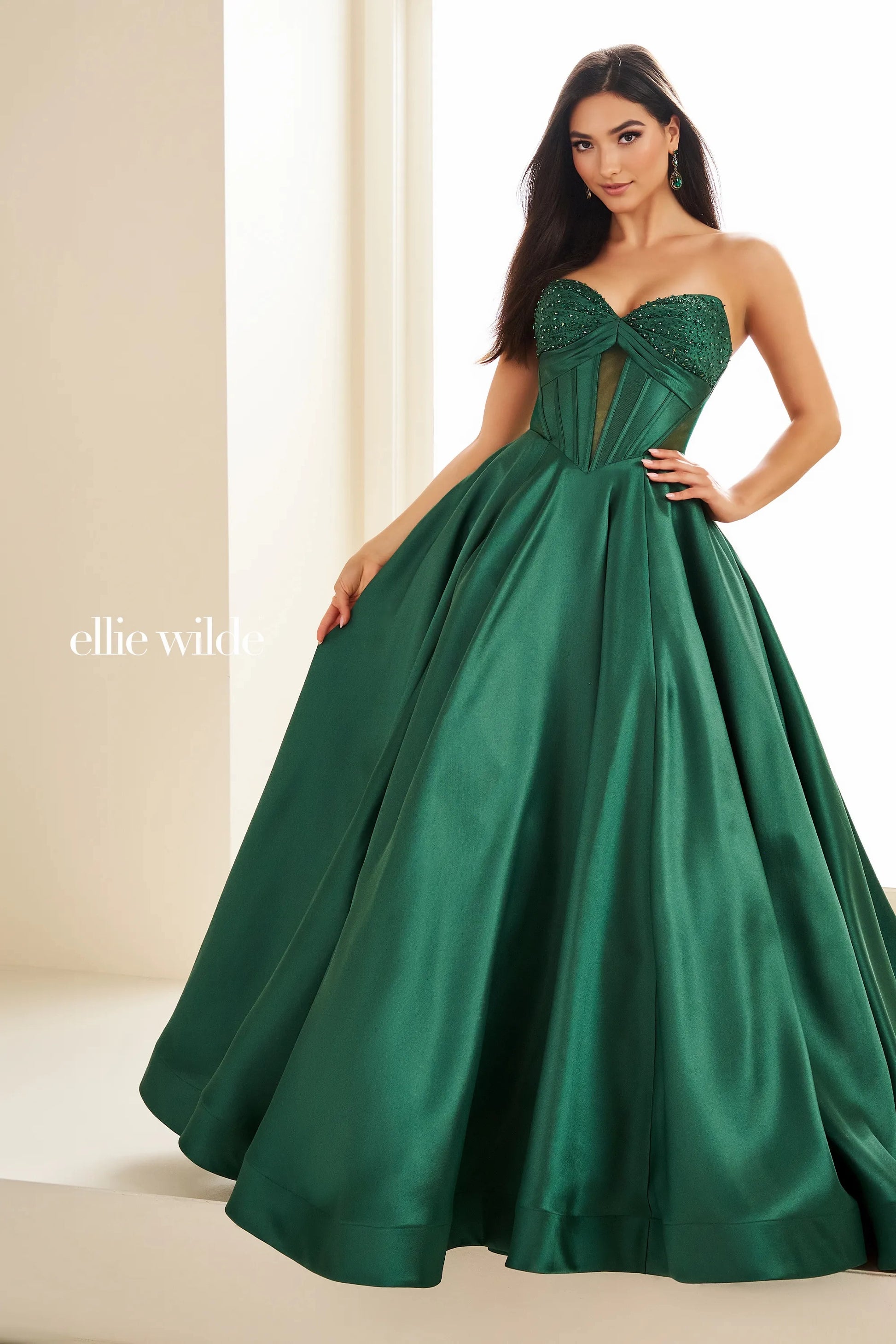 This Ellie Wilde EW36025 prom dress features a stunning A-line silhouette with sheer ballgown detailing and a corset back for a perfect fit. The dress also includes convenient pockets and cut-out design, making it both fashionable and functional for any pageant or formal event.