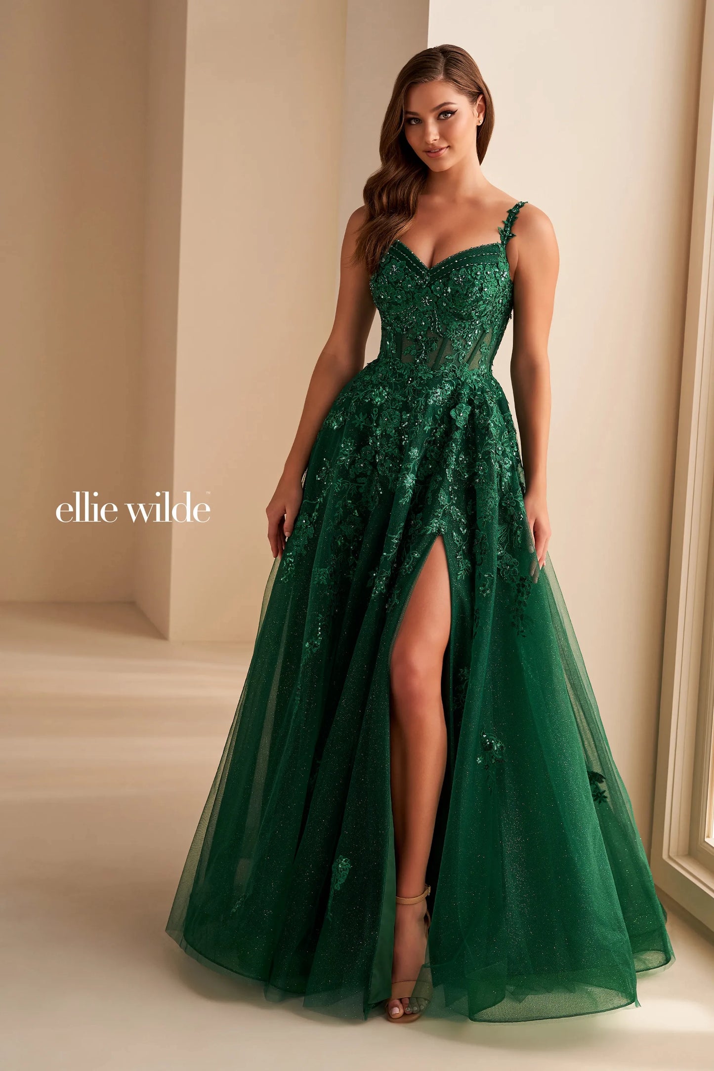 Experience the ultimate in elegance and glamour with the Ellie Wilde EW36204 prom dress. This stunning gown features a sequin lace corset bodice, sheer detailing, and an alluring slit. The off-the-shoulder neckline is adorned with intricate beading, adding a touch of sparkle to this already exquisite dress. Embody sophistication and grace on your special night.&nbsp;