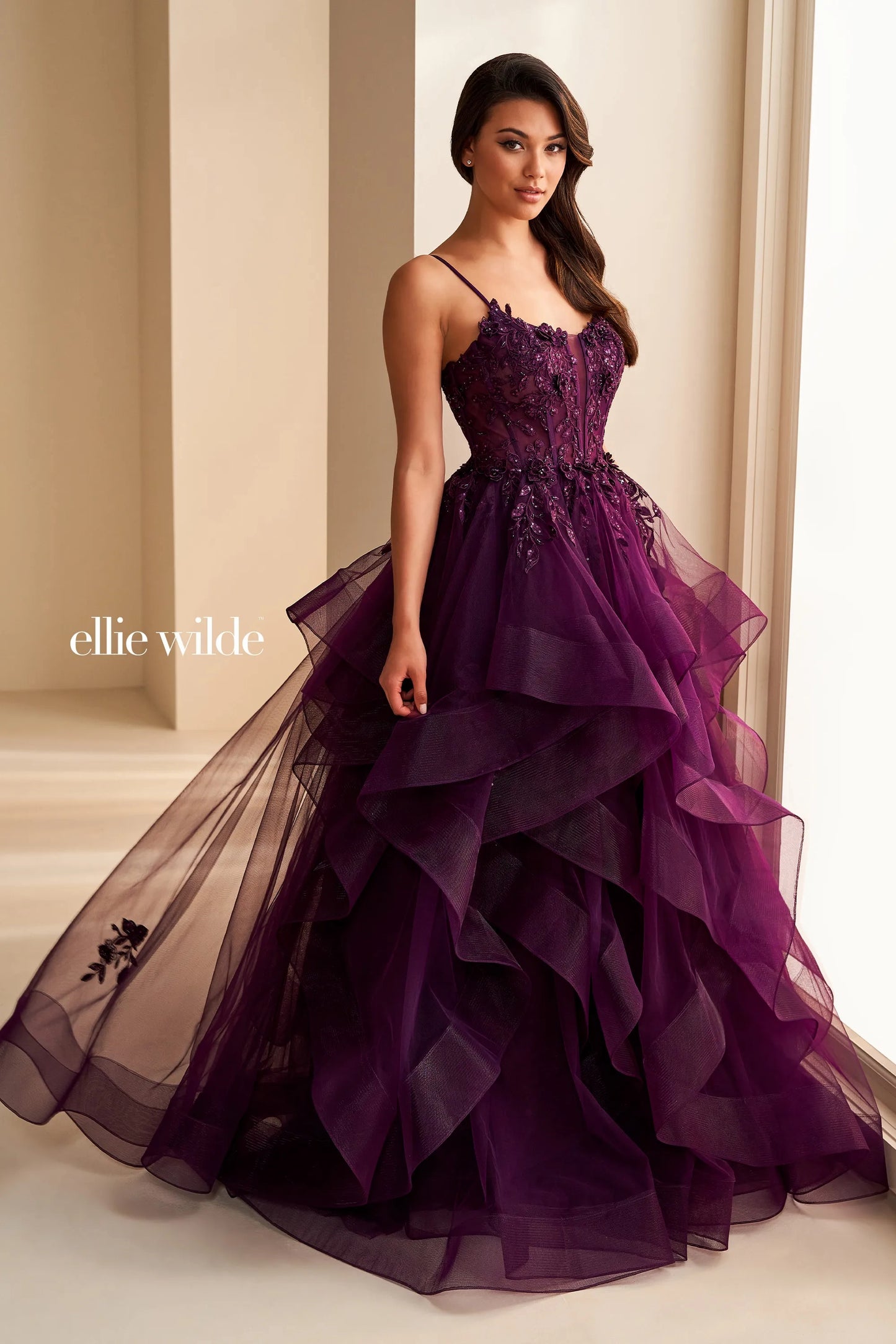 Step into elegance with the Ellie Wilde EW36225 Sheer Lace Corset Ball Gown. Featuring a stunning sheer lace bodice and layered corset, this formal evening gown is perfect for prom or any special occasion. Make a statement in this luxurious and exclusive dress, designed to make you feel like a work of art.