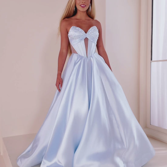 This Ellie Wilde EW36025 prom dress features a stunning A-line silhouette with sheer ballgown detailing and a corset back for a perfect fit. The dress also includes convenient pockets and cut-out design, making it both fashionable and functional for any pageant or formal event.