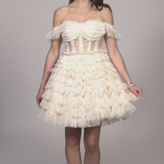 Discover the perfect combination of elegance and fun with the Dave &amp; Johnny 11754 Homecoming Dress. This stunning design features a sheer corset off the shoulder top, adorned with shimmery sequin layer tulle. With its playful cupcake skirt, this dress is guaranteed to make you stand out at any event.