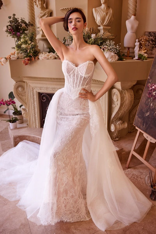 Elevate your wedding day style with the Ladivine WL044 Lace Corset Mermaid Wedding Dress. Featuring a delicate lace corset, this gown hugs your curves for a flattering fit. The overskirt adds a touch of drama and elegance, perfect for making a statement as you walk down the aisle. Complete with a strapless design and stunning train, this dress is the perfect choice for the modern bride. Embrace your elegance in this fitted wedding dress featuring a strapless sweetheart neckline and a sheer bodice, beautiful