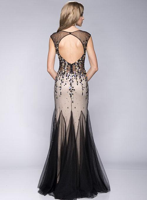 Envious Couture 15131 in Black/Nude. This gown features an illusion bodice that has cap sleeves and a scoop neckline for a lavish and enticing style. Sheer details and glittering crystals sparkle and shine creating a captivating ensemble that flutters to the full-length hemline, finished in a fancy fishtail silhouette.