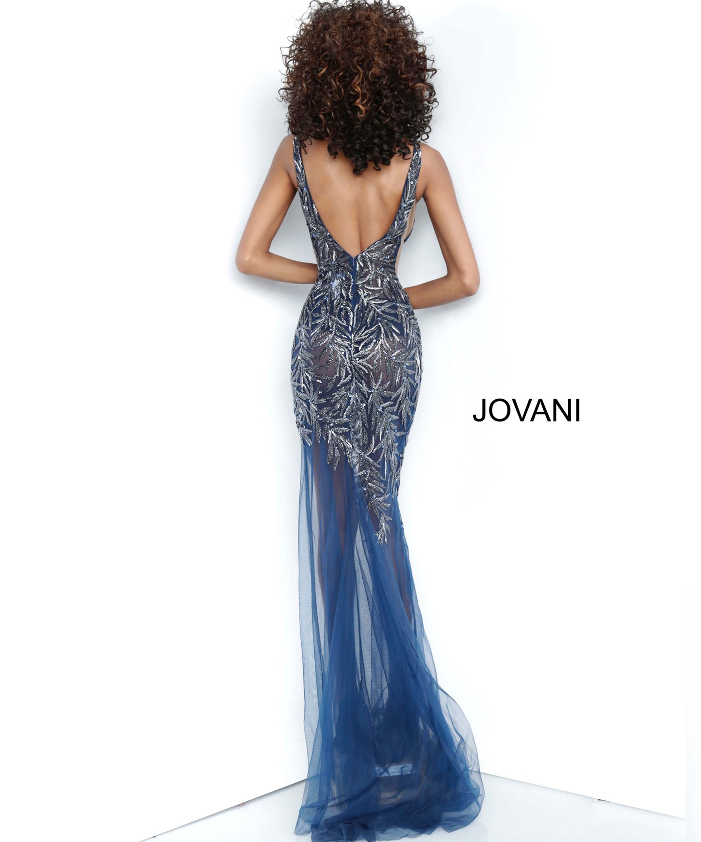 Jovani 1863 is a Gorgeous sheer Fully embellished Plunging Deep v neckline prom dress & Formal evening gown with slit in the sheer column skirt. Fully Embellished Crystal accented beaded sheer fitted bodice. Sheer side panels with mesh inserts.   Available colors:  Navy, Red, Silver/Nude, White  Available sizes:  00-24 