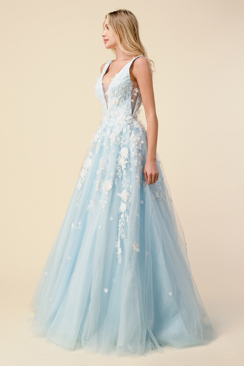 Andrea & Leo Gardenia A1028 Long Shimmer Ball Gown 3D Lace Formal Dress V Neck Gardenia gown is a layered tulle ball gown with floral diamond glitter motif trickling down the gown. 3D organza flowers add couture depth to the garment, while the pastel tone of the dress provides soft backdrop to the floral shimmer. The bodice features a illusion V-neckline with sheer side with deep V-back. The skirt is A-line shape with crinoline to support the silhouette.