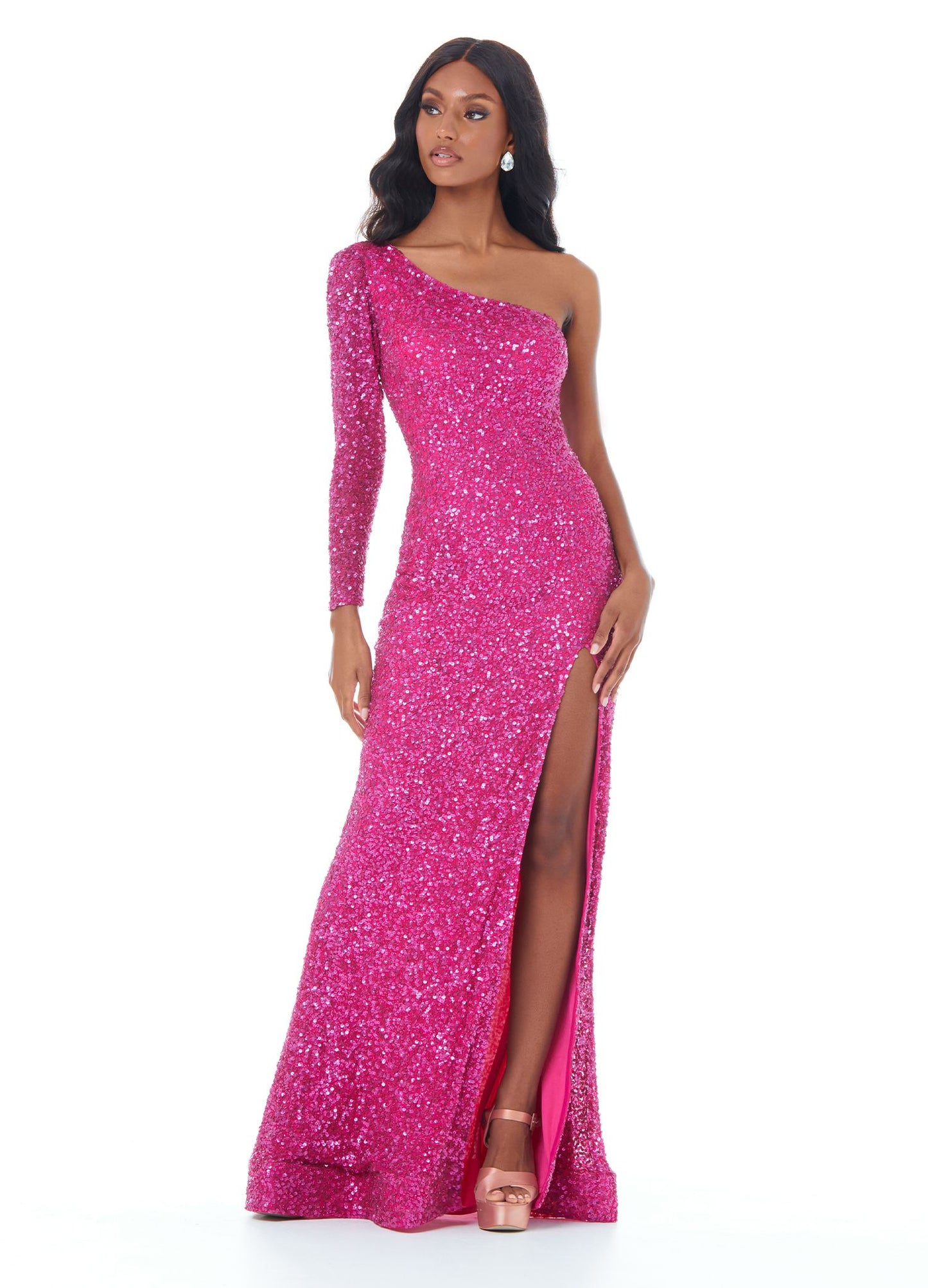 Ashley Lauren 1977 Fitted hand beaded prom dress featuring one sleeve and a left leg high slit. The long skirt on this evening gown is finished with horsehair trim for fullness. Makes an excellent pageant gown.   Available colors:  Raspberry, Silver/Pewter, Royal   Available sizes:  00, 0, 2, 4, 6, 8, 10, 12, 14, 16   One Shoulder Sleeve Slit Fitted Fully Hand Beaded Long Sleeve